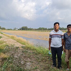 Zwei Männer vor einem Reisfeld