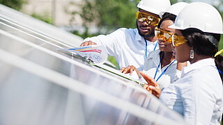 African american technicians check solar panels 