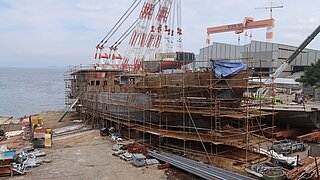 A ship under construction in a dock.