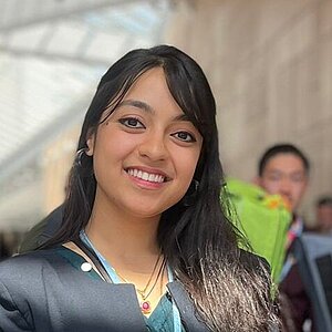 A young woman looks into the camera