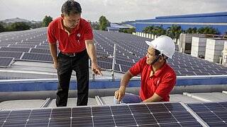 Two men working on a solar system