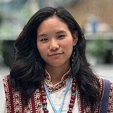 A young woman looks into the camera