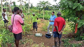 People standing in a circle on a field