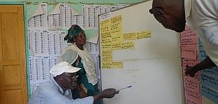 Discussion between two men and a woman at a workshop